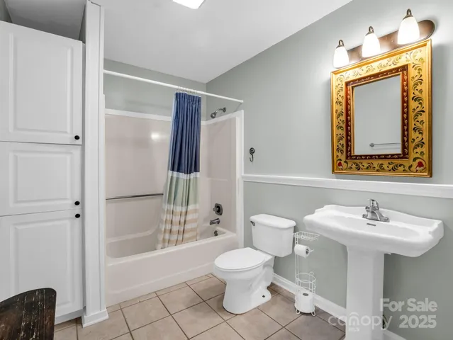 a bathroom with a sink a toilet and mirror