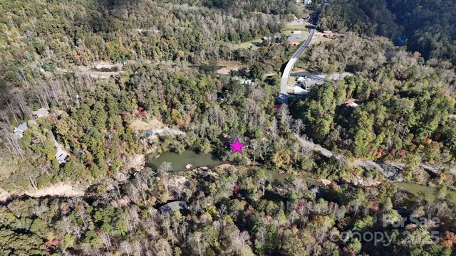 a view of a swimming pool with a patio and backyard
