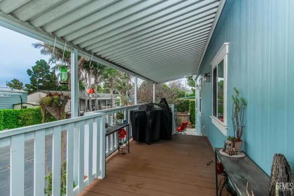 a living room with furniture and a dining table with wooden floor