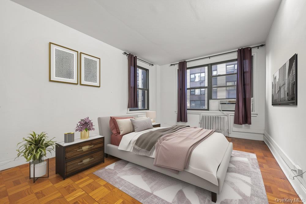 98-26 64th Avenue, Unit 3D Queens, NY 11374 - Photo 6 of 11 a spacious bedroom with a bed and a large window