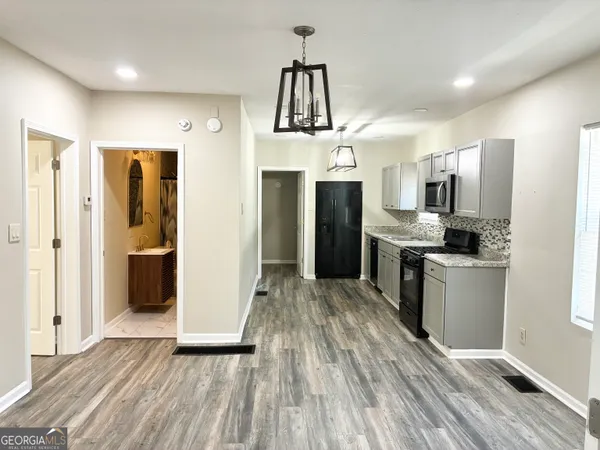 an empty room with wooden floor and a window