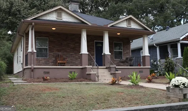 a front view of a house with garden