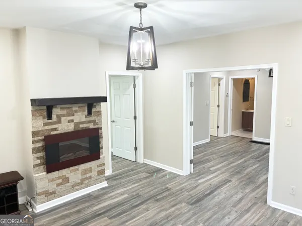 a view of a hallway with wooden floor and a fireplace