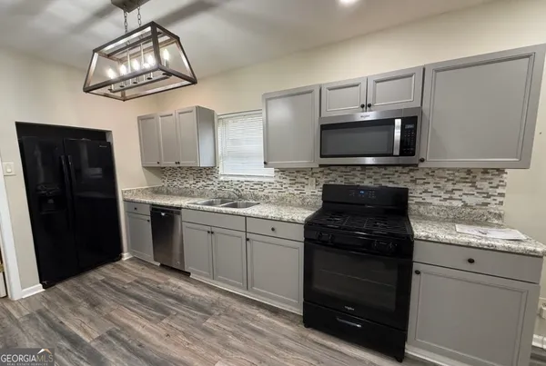a kitchen with a refrigerator stove and sink