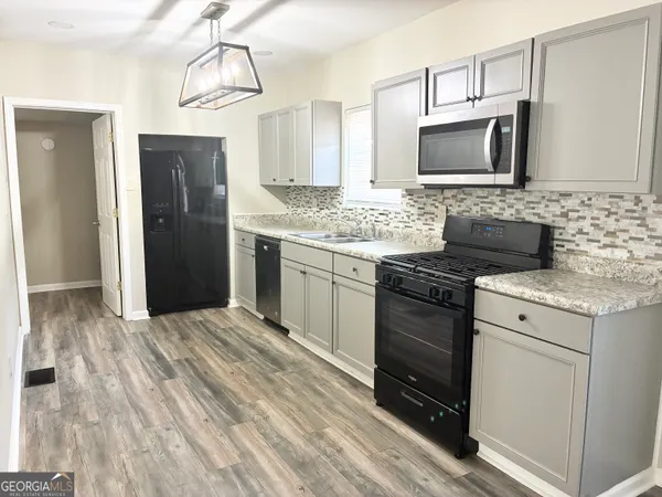 a kitchen with a stove microwave and refrigerator