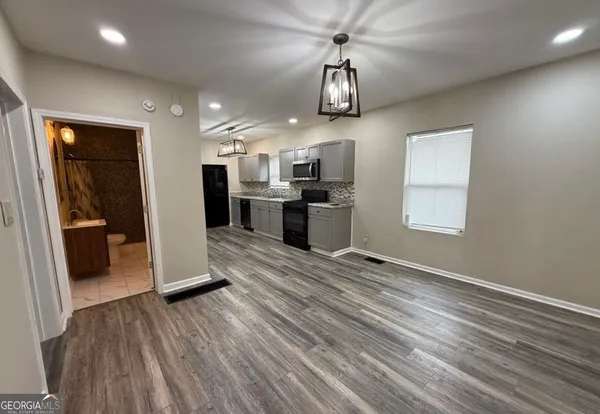 a kitchen with sink cabinets and wooden floor