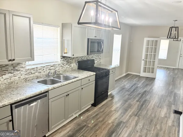 a view of a dining room with furniture wooden floor and chandelier