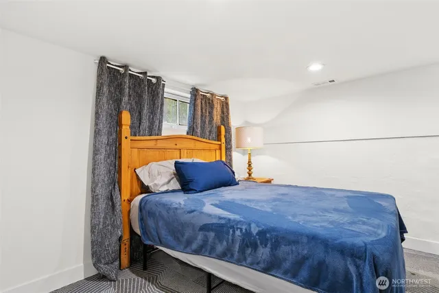 a bedroom with a bed and a view of bathroom