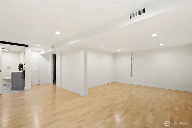 a living room with lots of furniture and view of kitchen
