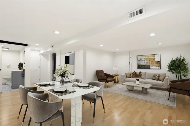 a living room with furniture and a wooden floor