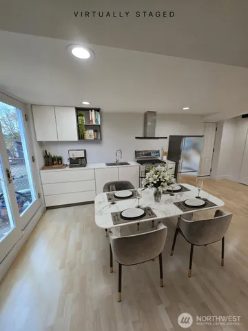 a view of a wooden house with a barbeque and wooden stairs