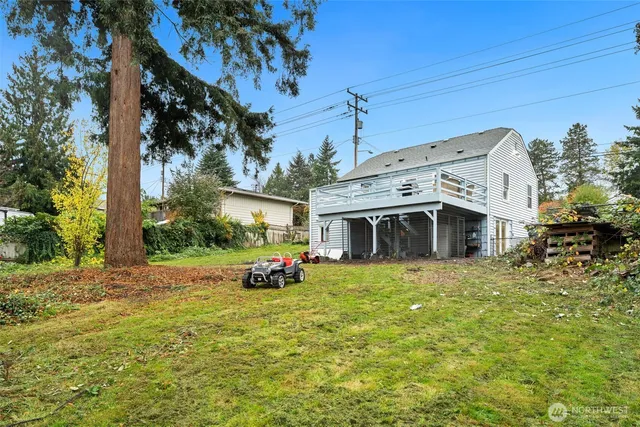 a view of a backyard with large trees and plants