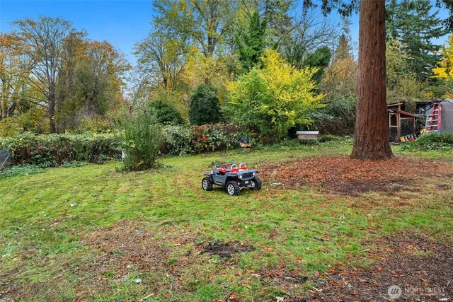 a view of a house with backyard water fountain and sitting area