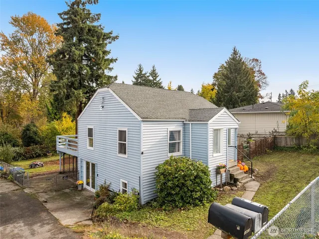 a view of a house with a yard and sitting area