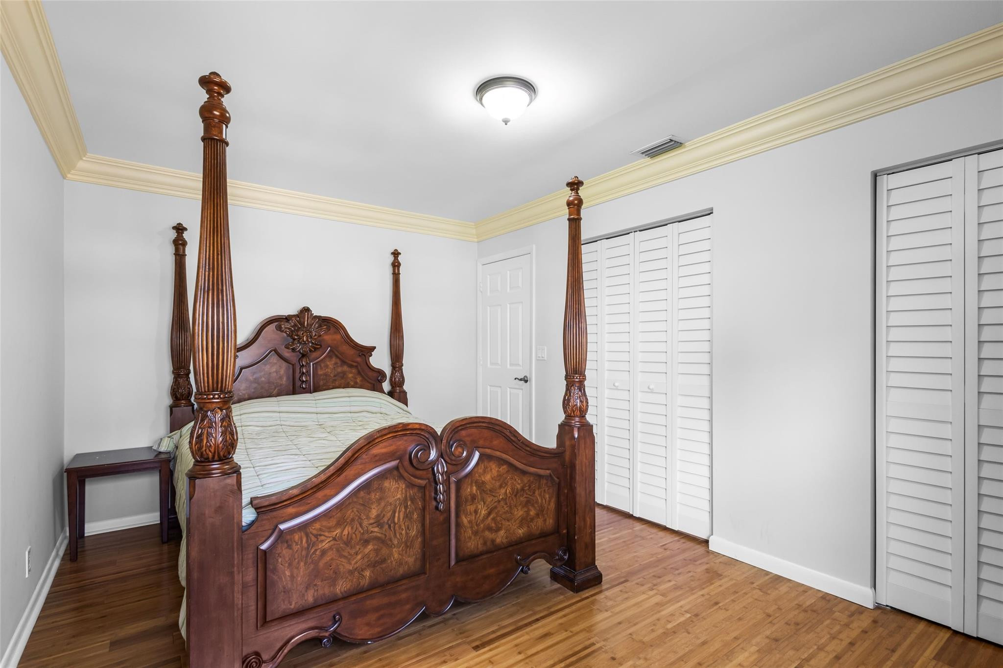 5223 Deerhurst Crescent Circle Boca Raton, FL 33486 - Photo 41 of 51 a bedroom with a bed and wooden floor