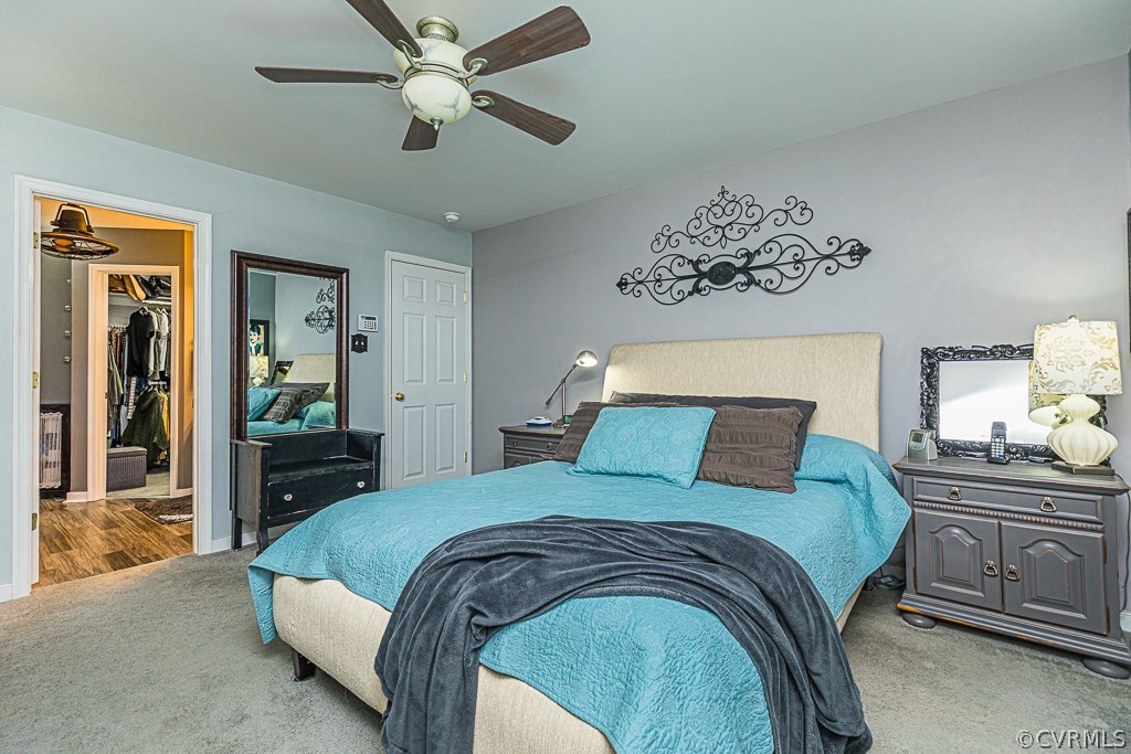 3620 Winterhaven Road Midlothian, VA 23112 - Photo 20 of 42 a bedroom with a large bed and a chandelier
