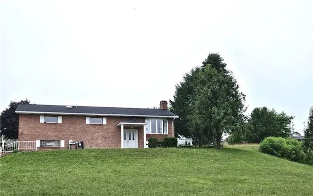 a front view of a house with a garden