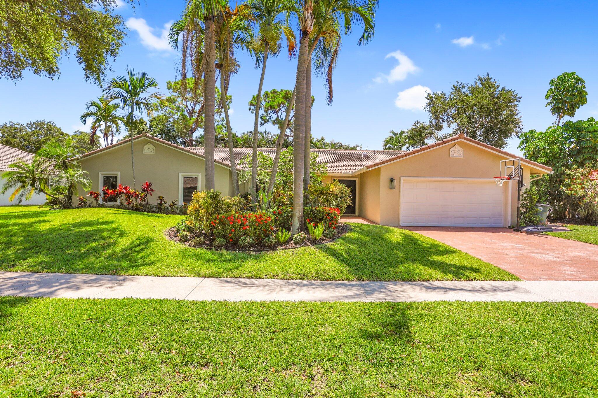 6769 Entrada Place Boca Raton, FL 33433 - Photo 1 of 47 a front view of a house with garden