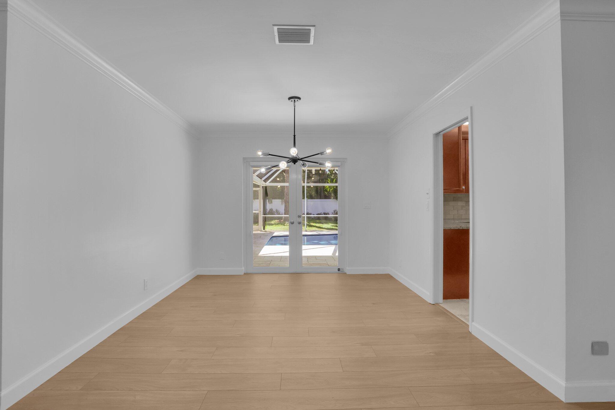 6769 Entrada Place Boca Raton, FL 33433 - Photo 12 of 47 an empty room with windows and entrance