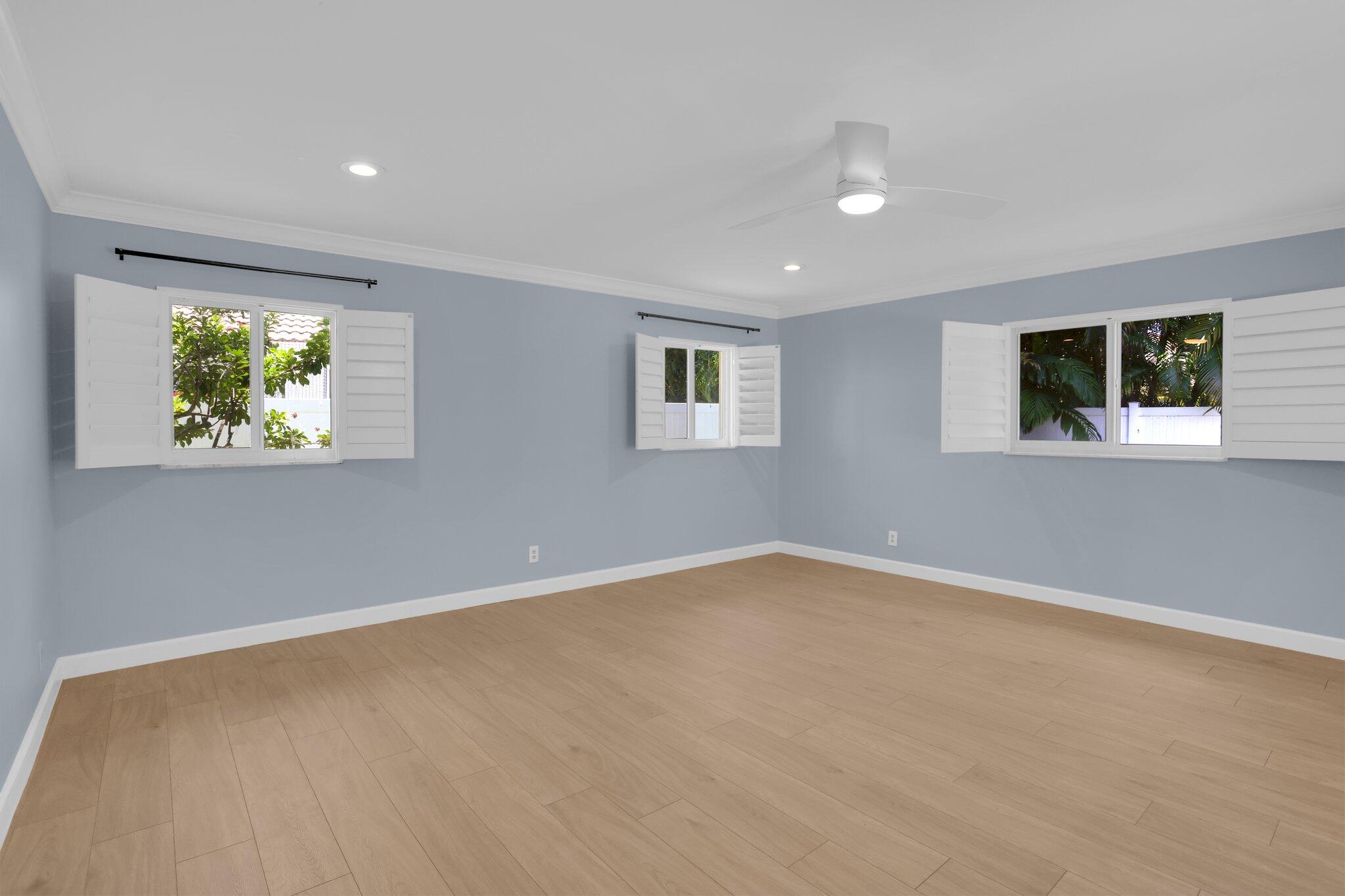6769 Entrada Place Boca Raton, FL 33433 - Photo 14 of 47 a view of an empty room with window and wooden floor