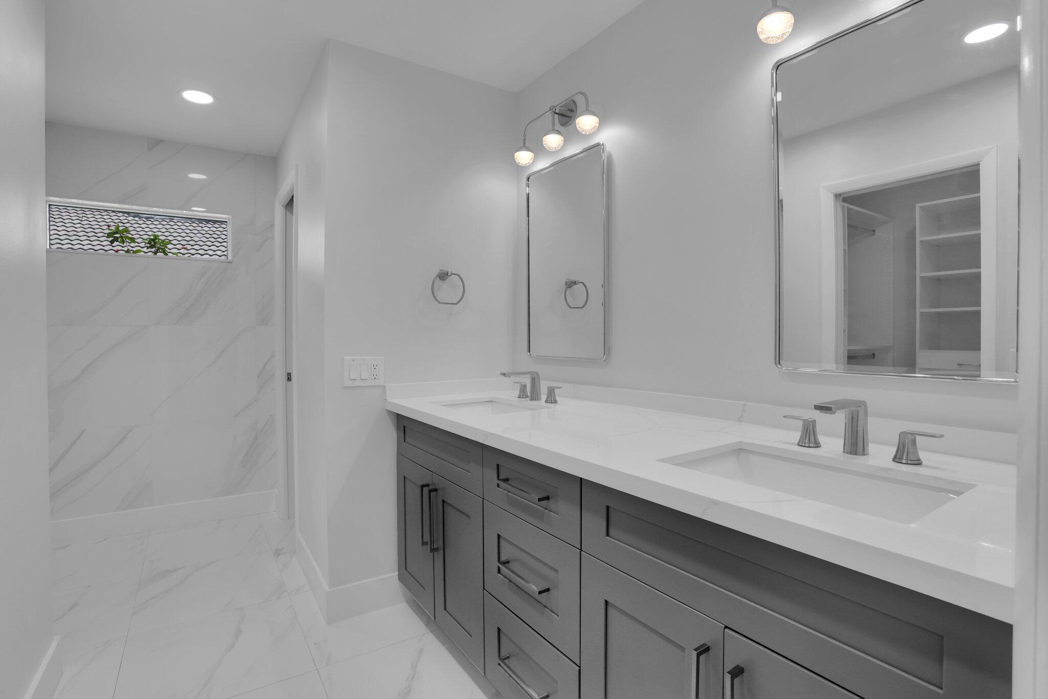 6769 Entrada Place Boca Raton, FL 33433 - Photo 16 of 47 a bathroom with double sink and a mirror