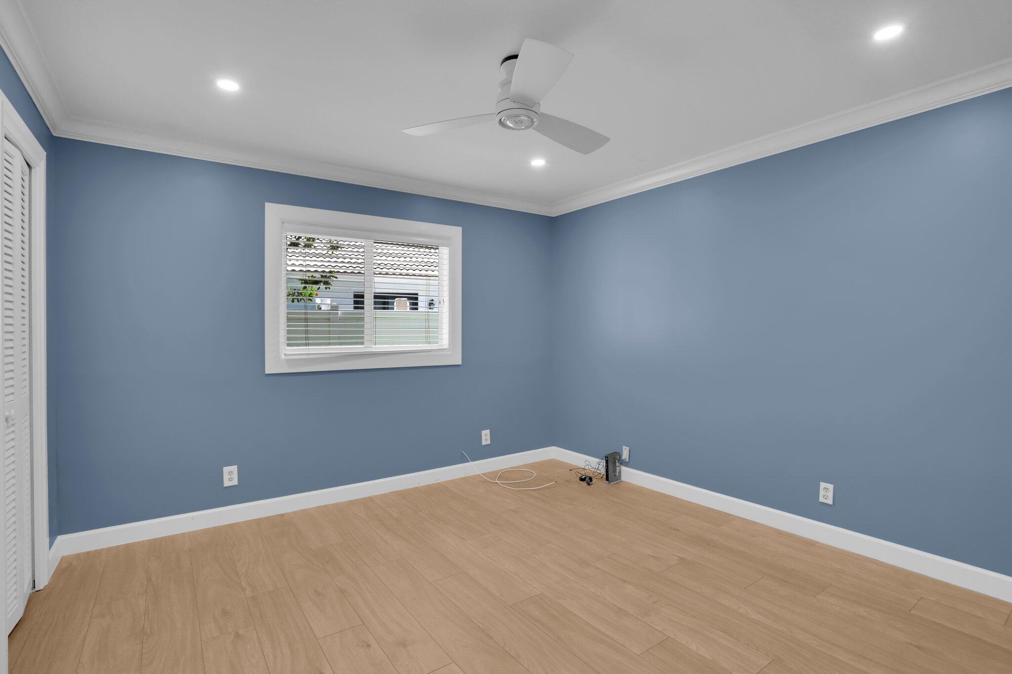 6769 Entrada Place Boca Raton, FL 33433 - Photo 23 of 47 an empty room with windows and ceiling fan
