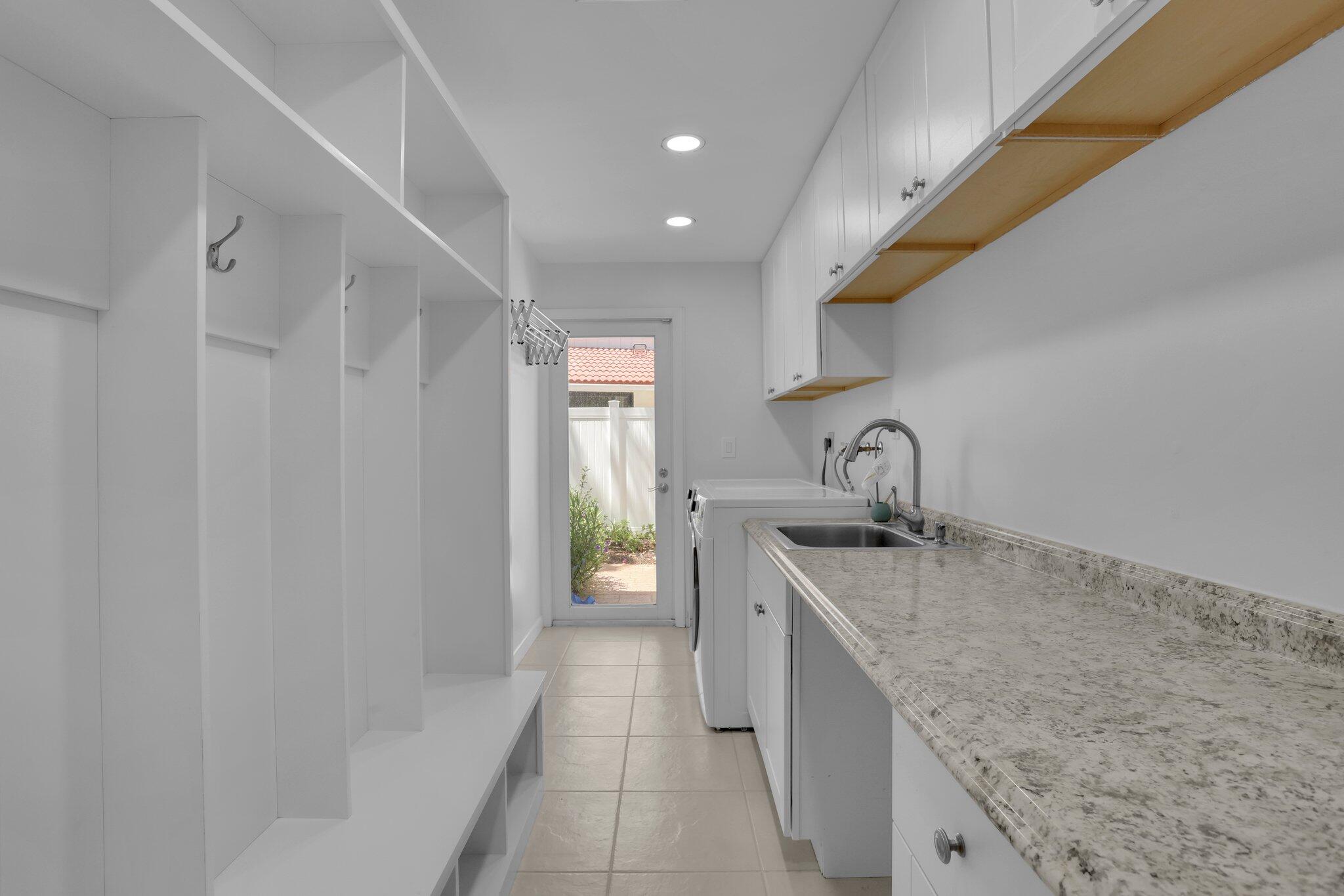 6769 Entrada Place Boca Raton, FL 33433 - Photo 31 of 47 a kitchen with a sink a faucet and cabinets
