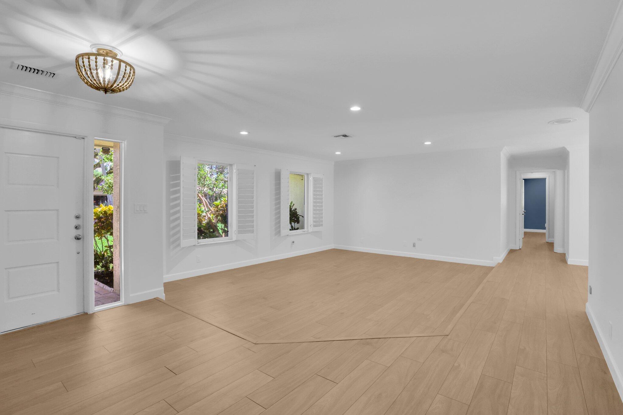 6769 Entrada Place Boca Raton, FL 33433 - Photo 5 of 47 an empty room with windows and chandelier