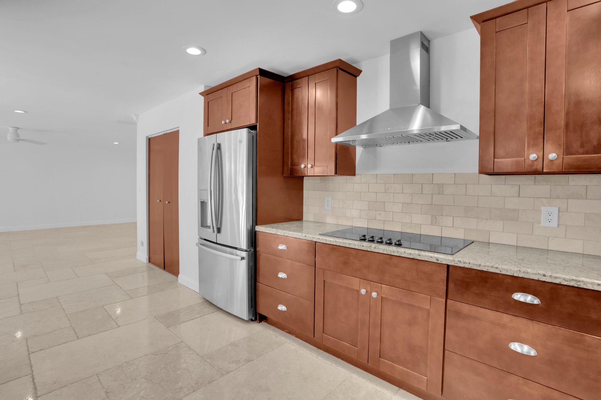 6769 Entrada Place Boca Raton, FL 33433 - Photo 6 of 47 a kitchen with stainless steel appliances granite countertop a refrigerator and a stove