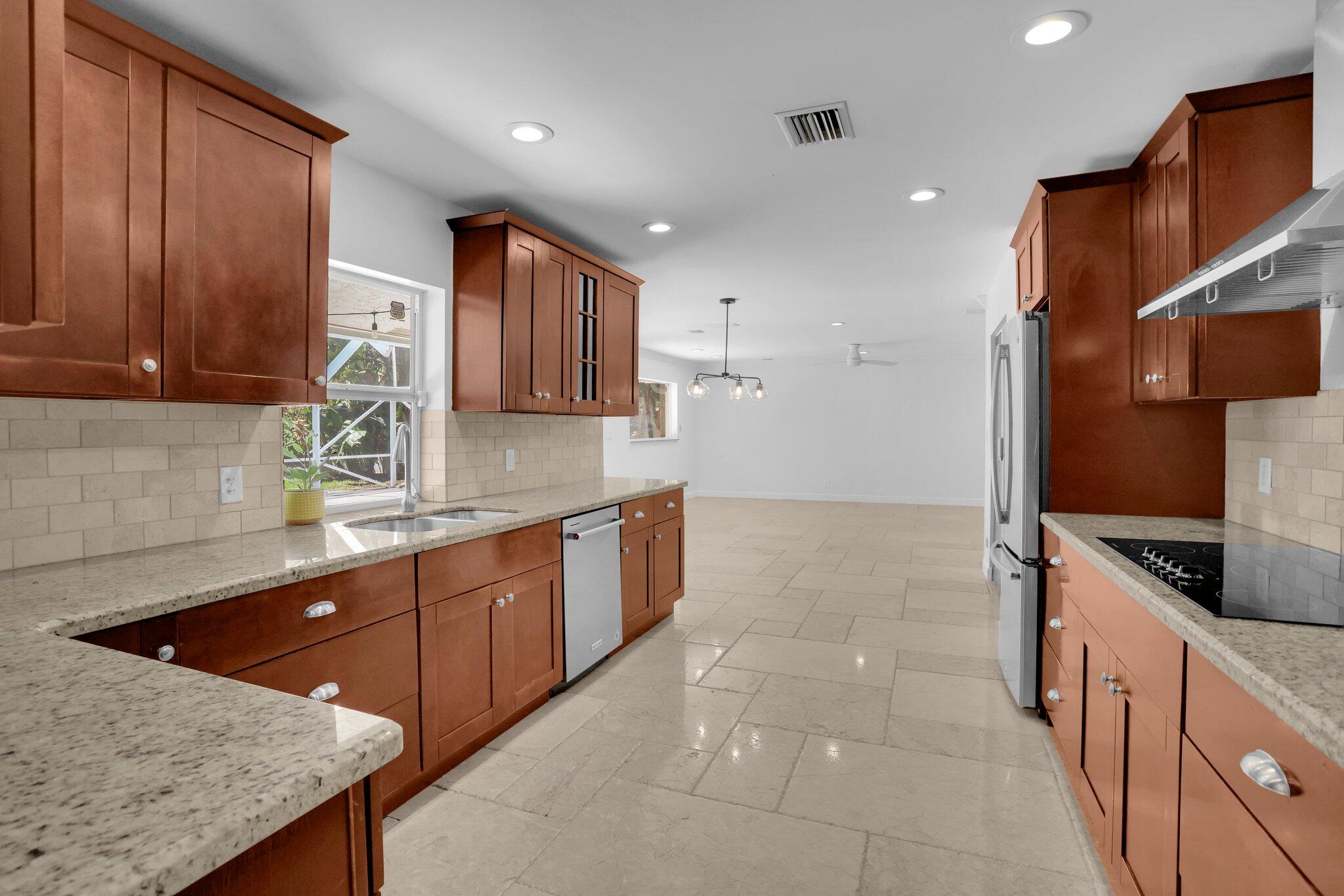 6769 Entrada Place Boca Raton, FL 33433 - Photo 7 of 47 a kitchen with granite countertop a sink and cabinets