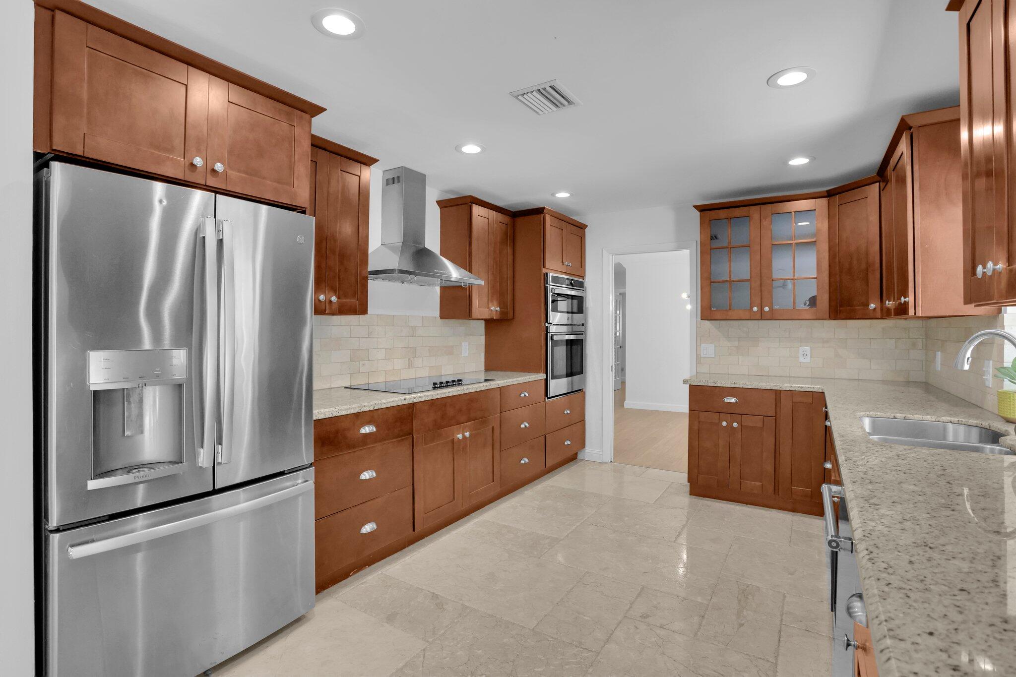 6769 Entrada Place Boca Raton, FL 33433 - Photo 8 of 47 a kitchen with stainless steel appliances granite countertop a refrigerator and a sink