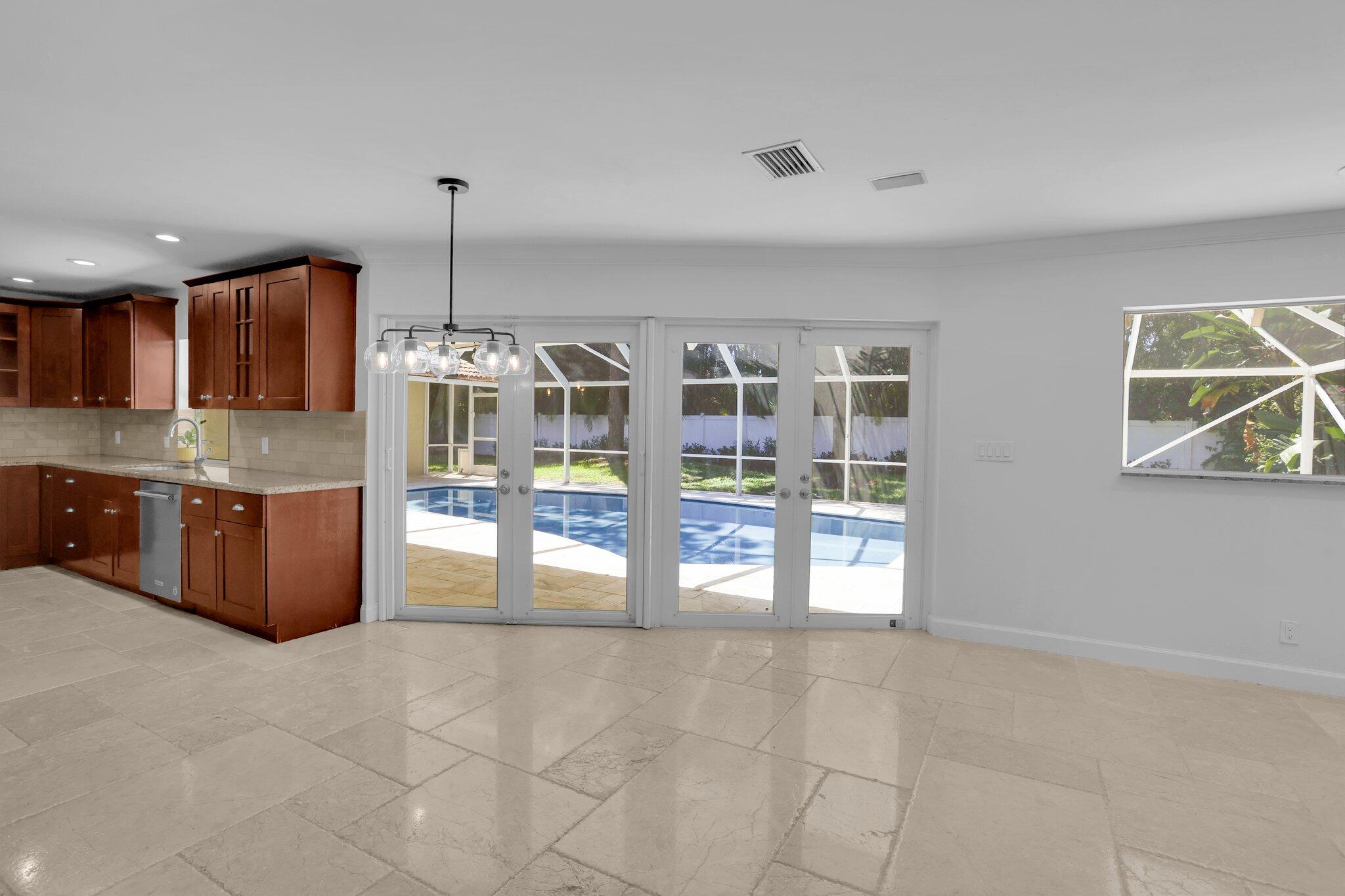 6769 Entrada Place Boca Raton, FL 33433 - Photo 10 of 47 a large kitchen with granite countertop a large counter top cabinets and stainless steel appliances