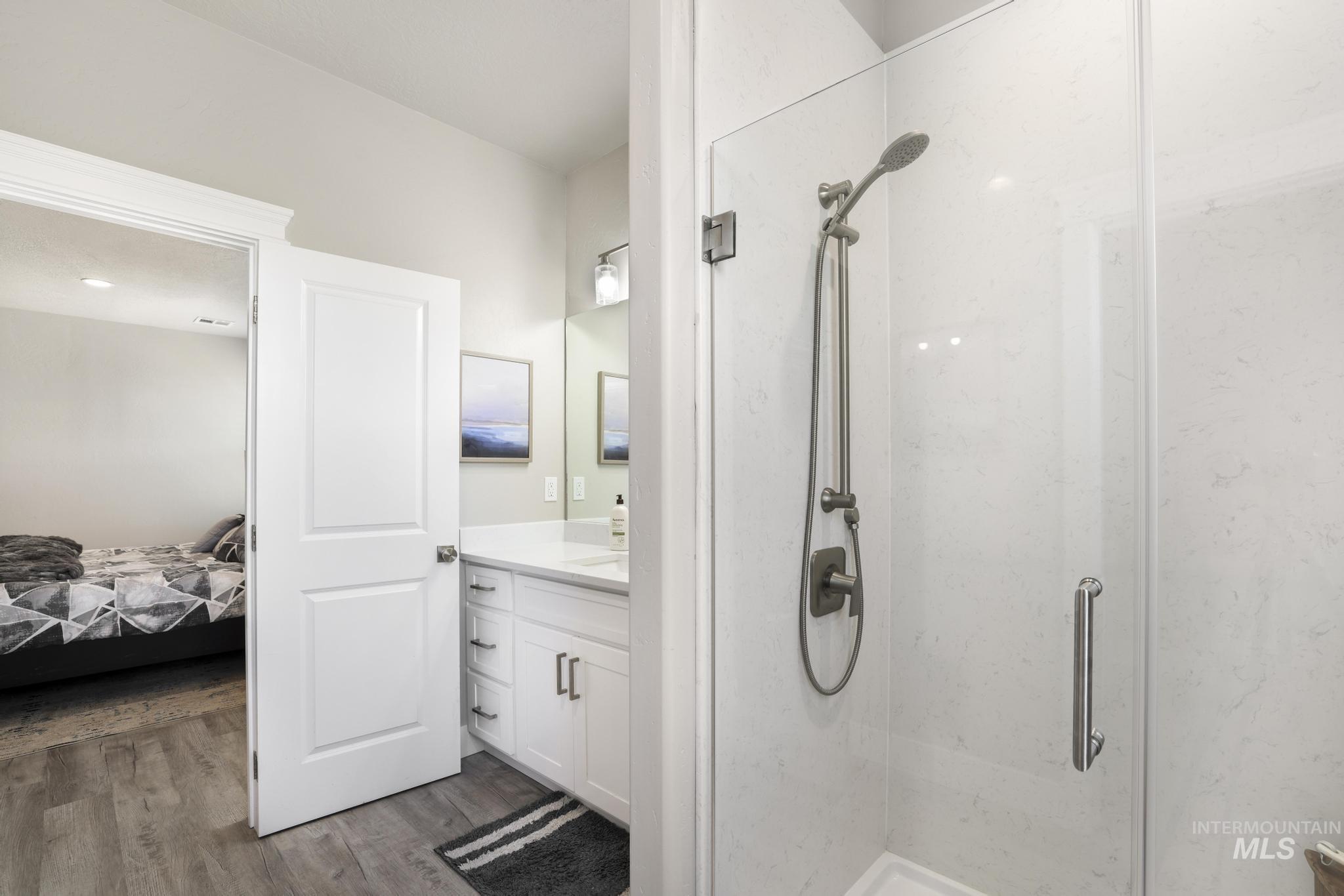 758 Cedar Crk Road Rogerson, ID 83302 - Photo 22 of 50 Glass-enclosed shower with brushed nickel fixtures and white tile surround