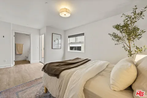 a bedroom with a bed and a chandelier