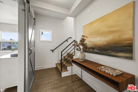 a view of entryway and hall with wooden floor