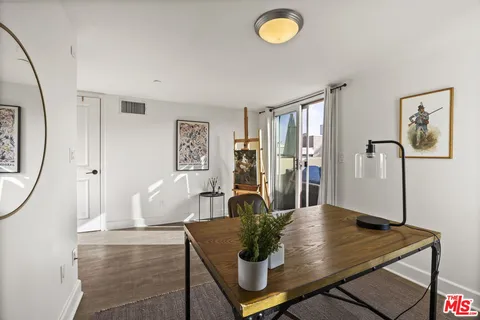 a view of a dining room with furniture and a potted plant