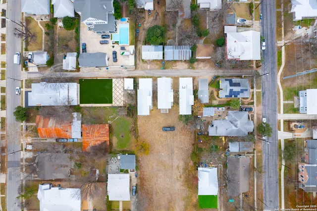 an aerial view of residential houses with outdoor space