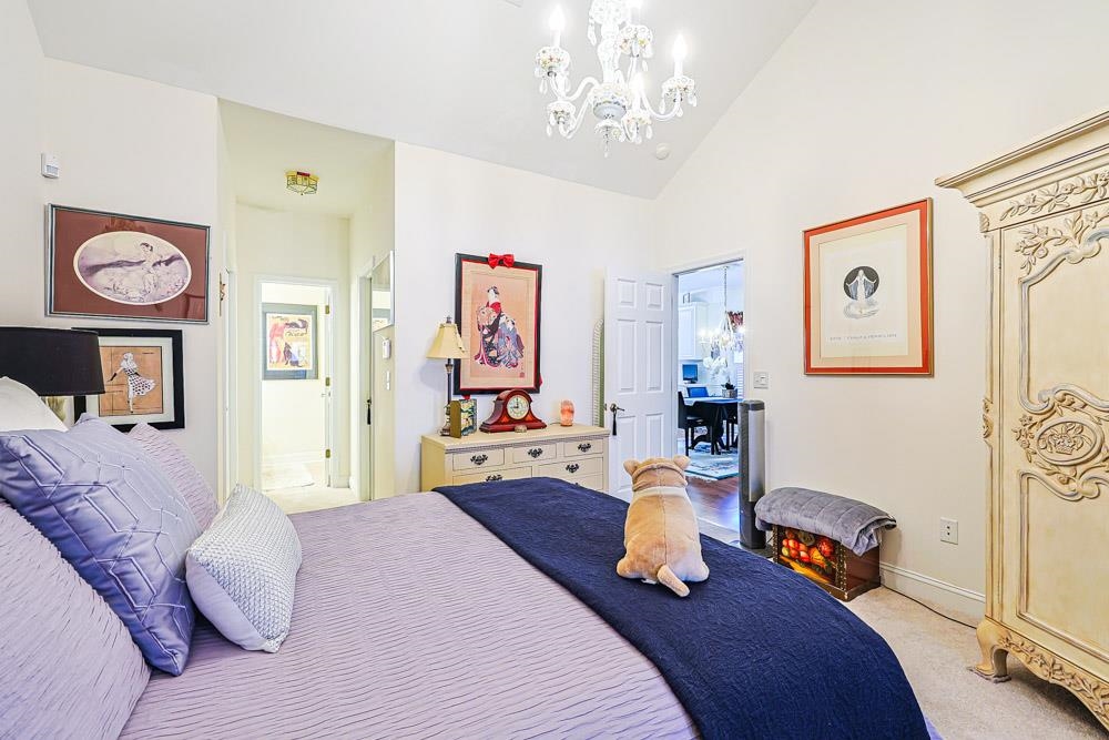 815 Botany Loop, Unit 815 Murrells Inlet, SC 29576 - Photo 13 of 40 Bedroom featuring a chandelier, carpet floors, high vaulted ceiling, and connected bathroom
