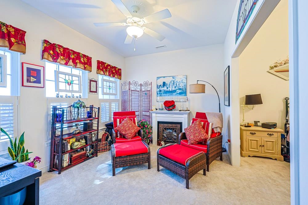 815 Botany Loop, Unit 815 Murrells Inlet, SC 29576 - Photo 15 of 40 Living area featuring light carpet, ceiling fan, and a fireplace