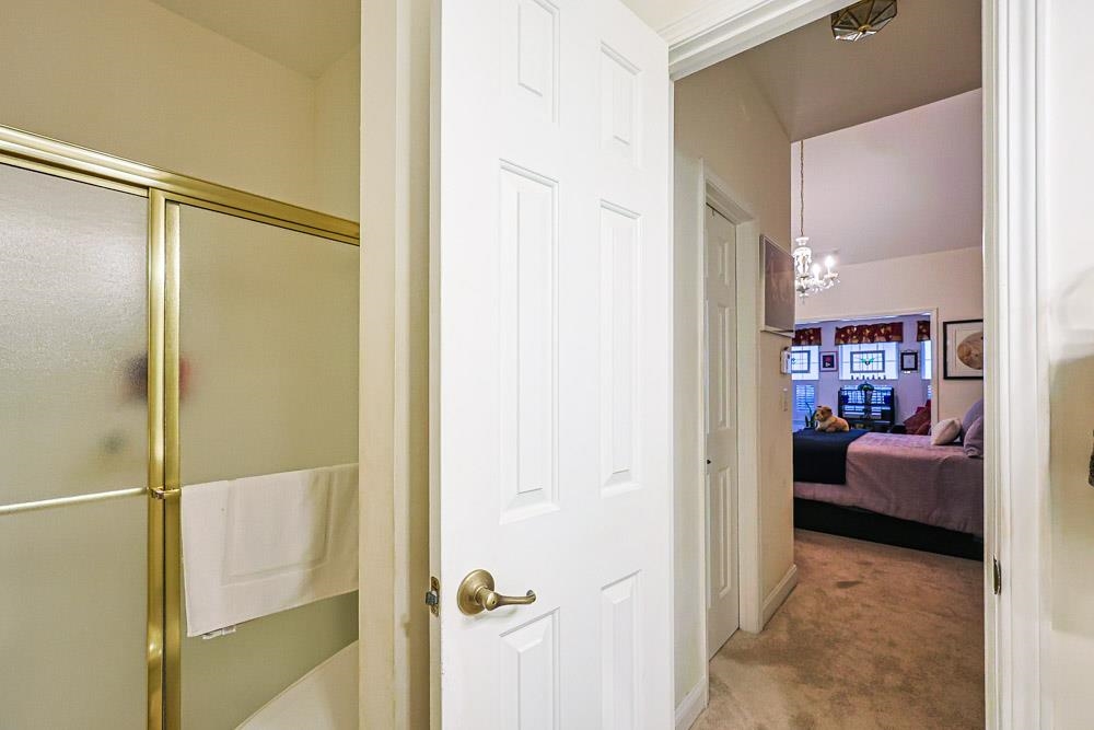 815 Botany Loop, Unit 815 Murrells Inlet, SC 29576 - Photo 18 of 40 Ensuite bathroom featuring light colored carpet, a shower stall, and a chandelier