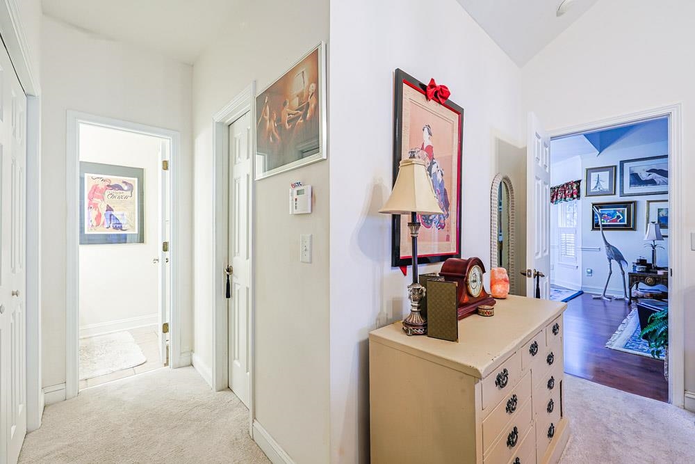 815 Botany Loop, Unit 815 Murrells Inlet, SC 29576 - Photo 19 of 40 Hallway featuring light carpet and vaulted ceiling