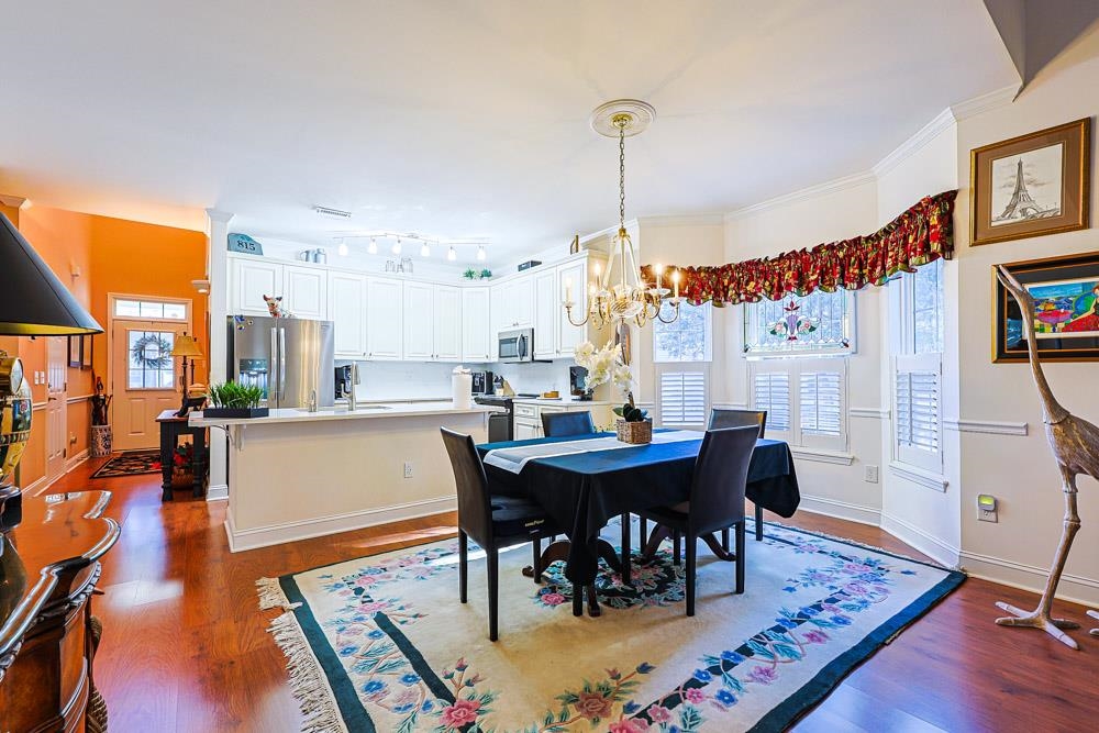 815 Botany Loop, Unit 815 Murrells Inlet, SC 29576 - Photo 5 of 40 Dining area featuring dark wood-style flooring and a chandelier