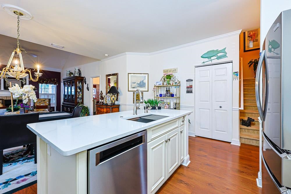 815 Botany Loop, Unit 815 Murrells Inlet, SC 29576 - Photo 8 of 40 Kitchen with stainless steel appliances, white cabinets, dark wood-style floors, pendant lighting, and a kitchen island with sink