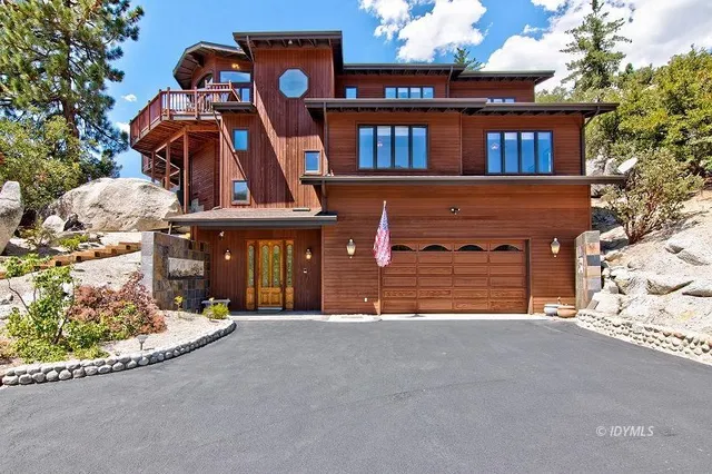 a room with two chair and a potted plant