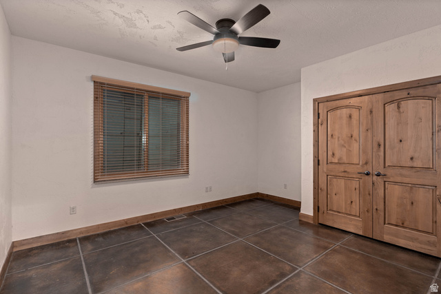 2464 East Granite Way St. George, UT 84790 - Photo 95 of 106 Unfurnished first bedroom with a ceiling fan and a closet