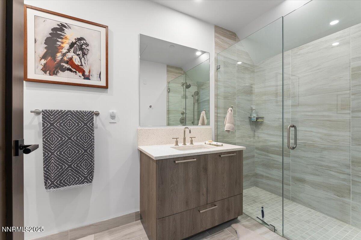 33 Beach Club Drive, Unit 506 Stateline, NV 89449 - Photo 15 of 44 a bathroom with a sink a mirror and a shower