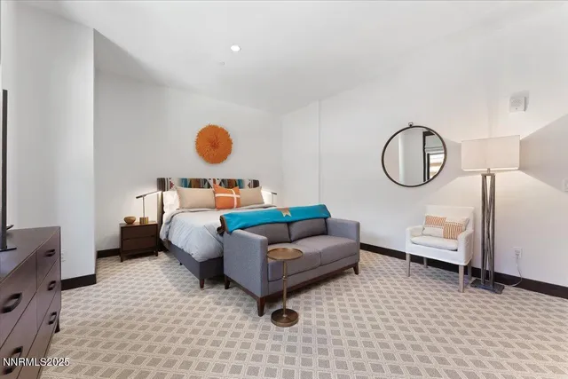 a living room with furniture and a mirror