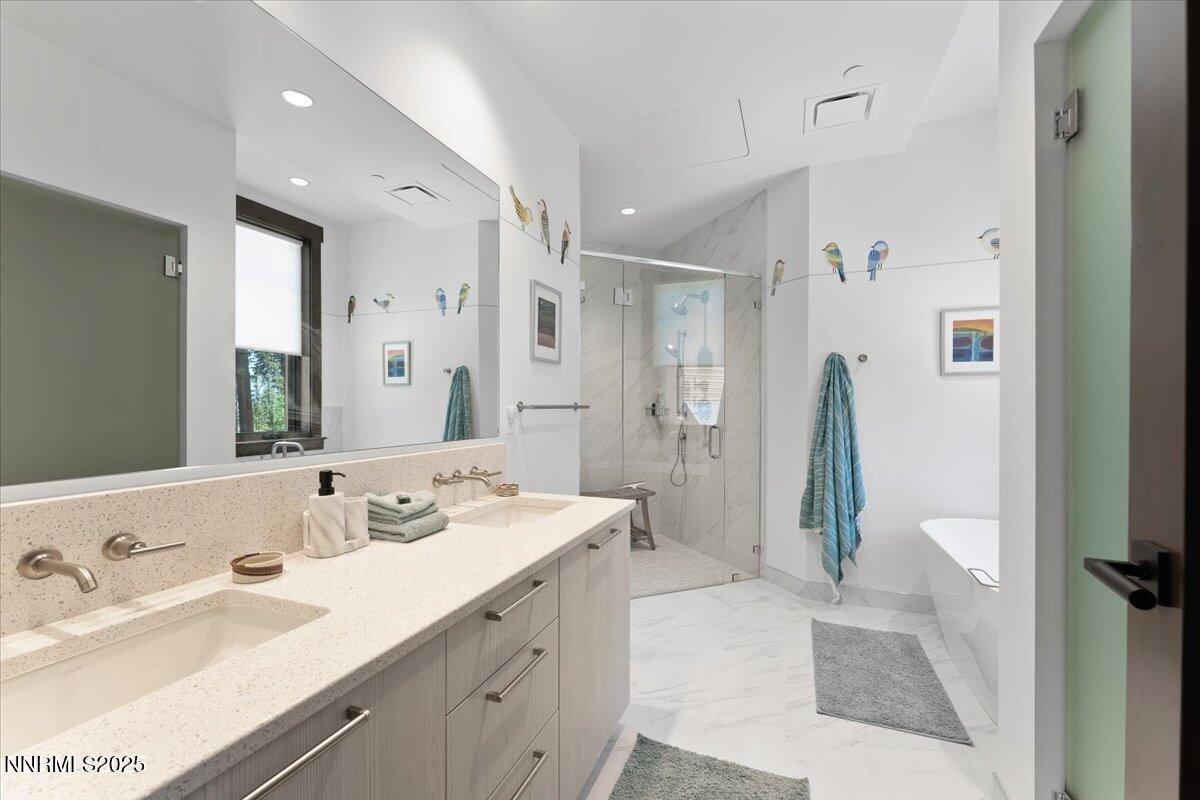 33 Beach Club Drive, Unit 506 Stateline, NV 89449 - Photo 8 of 44 a spacious bathroom with a double vanity sink a mirror and a shower