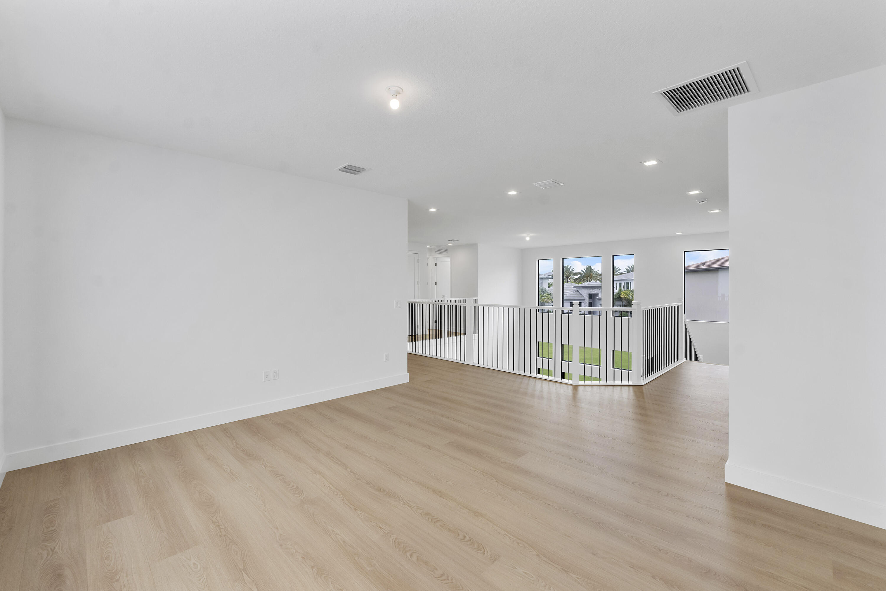 9322 Sunflower Mdw Road Boca Raton, FL 33434 - Photo 42 of 87 a view of an empty room with wooden floor and kitchen