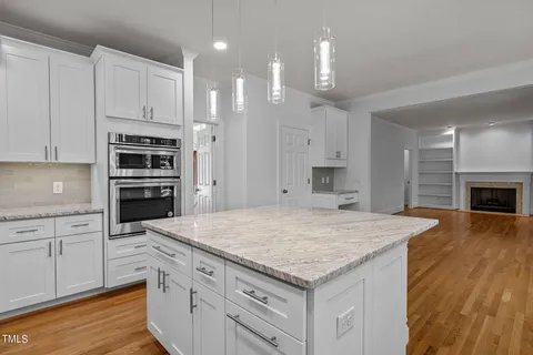 a kitchen with kitchen island a sink stainless steel appliances and cabinets